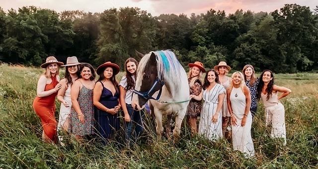 Group of women with a horse in the field